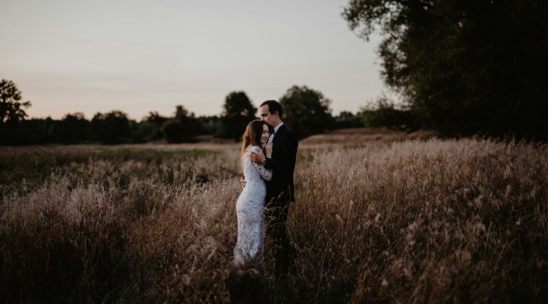man and woman standing on grass